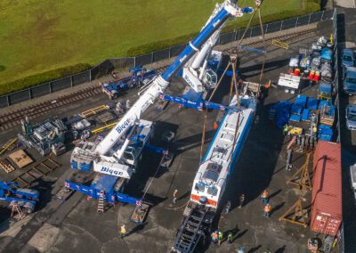 Cranes hoisting maintenance equipment for BART